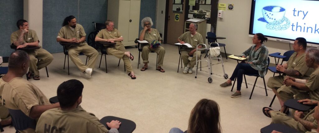 A Try Think session at Halawa Correctional Facility. The participant at center top is holding the yarn community ball which gives him the floor.