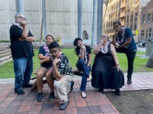 Lee Tonouchi and 5 of his playwriting students all wearing lei and striking poses of contemplation.